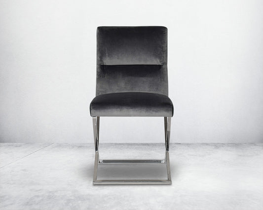 Dining chair with front upholstered in fabric with high polished stainless steel legs in a cross design.