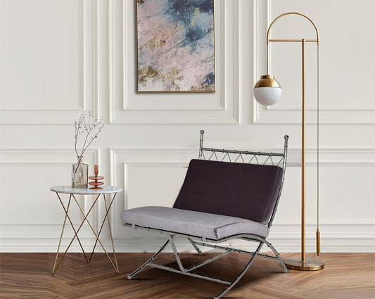 Lounge chair with stool and decor light upholstered in fabric with high polished stainless steel frame in bamboo design.