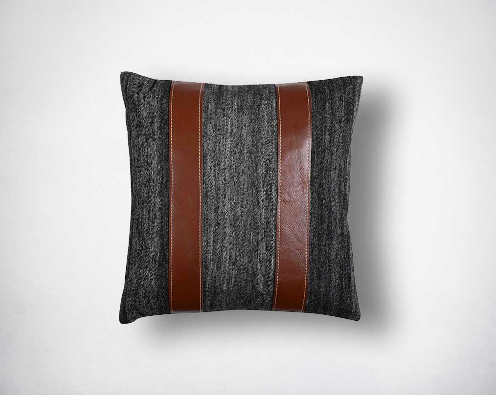 Dark grey & brown cut-out fabric & leather cushion.