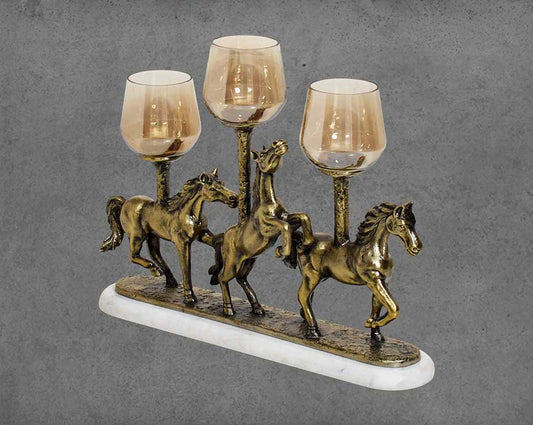 This vintage rearing three horses pillar candle holder in a light antique gold rustic finish with brown side view