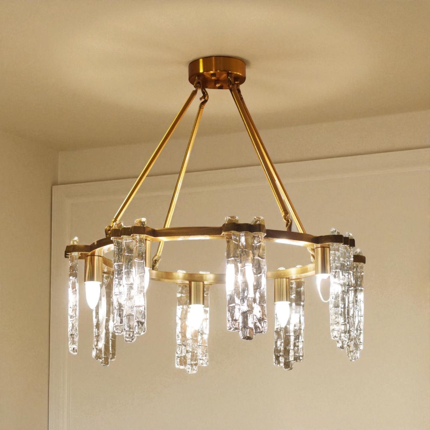 Gold chandelier with crystal accents on a beige ceiling