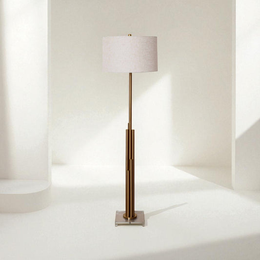 Floor lamp with a white shade and bronze base on a white background