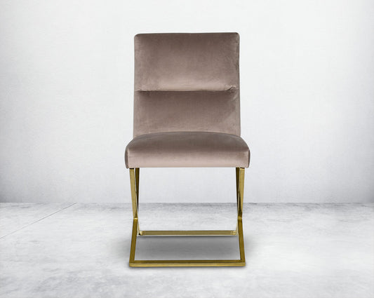 Dining chair with front upholstered in fabric with gold plated stainless steel legs in a cross design.