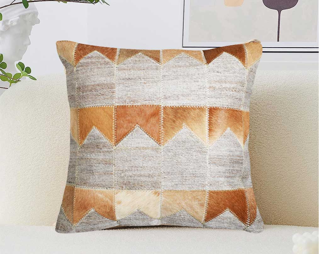 Beige, grey and tan cut-out fabric and leather hair on the cushion.