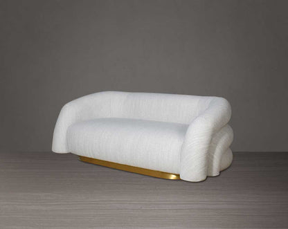 This modern chic 2 sofa in soft form upholstered in high-quality fabric crafted like soft bun with puffy rounded/ tubular back & armrest with stainless steel velvet brushed gold base is a design