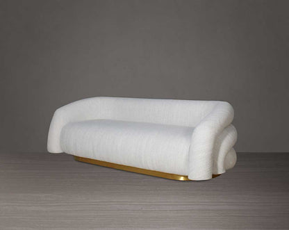 This modern chic 3 sofa in soft form upholstered in high-quality fabric crafted like soft bun with puffy rounded/ tubular back & armrest with stainless steel velvet brushed gold base is a design