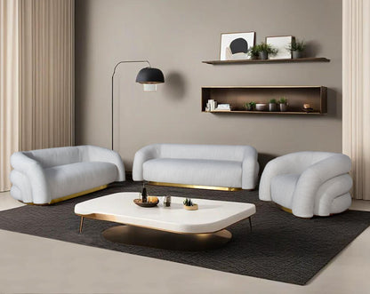 This modern chic 3+2+1 sofa in soft form upholstered in high-quality fabric crafted like soft bun with puffy rounded/ tubular back & armrest with stainless steel velvet brushed gold base is a design