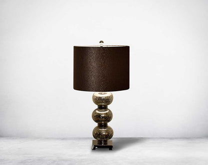 Table lamp with tinted crystal orbs on a silver-plated metal base with black translucent fabric shade.