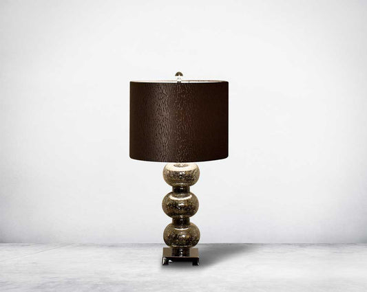 Table lamp with tinted crystal orbs on a silver-plated metal base with black translucent fabric shade.