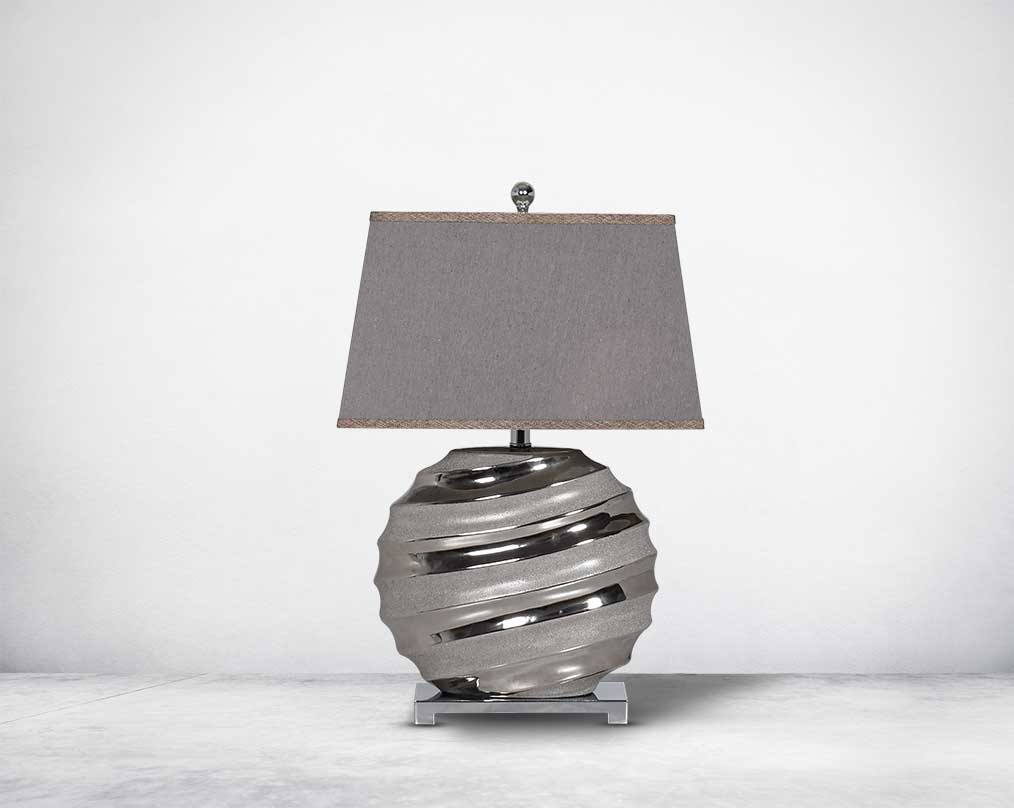 Silver table lamp in ceramic with metal base & translucent fabric shade.