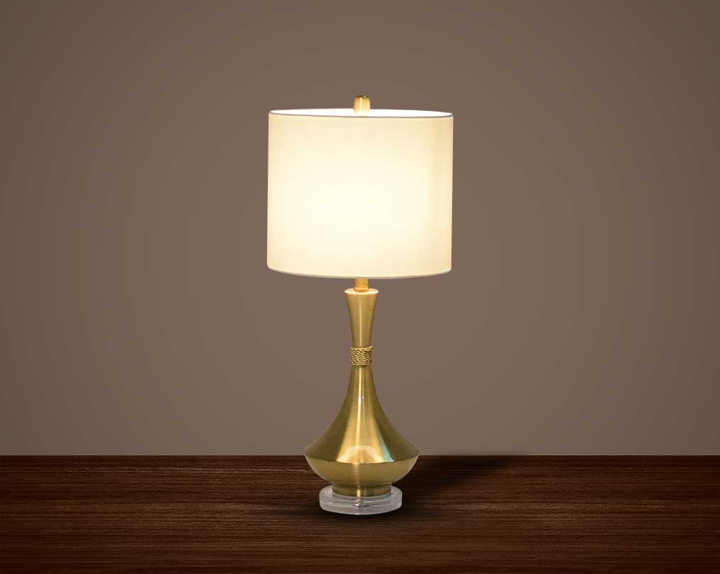 Table lamp in metallic gold and crystal with translucent fabric shade.
