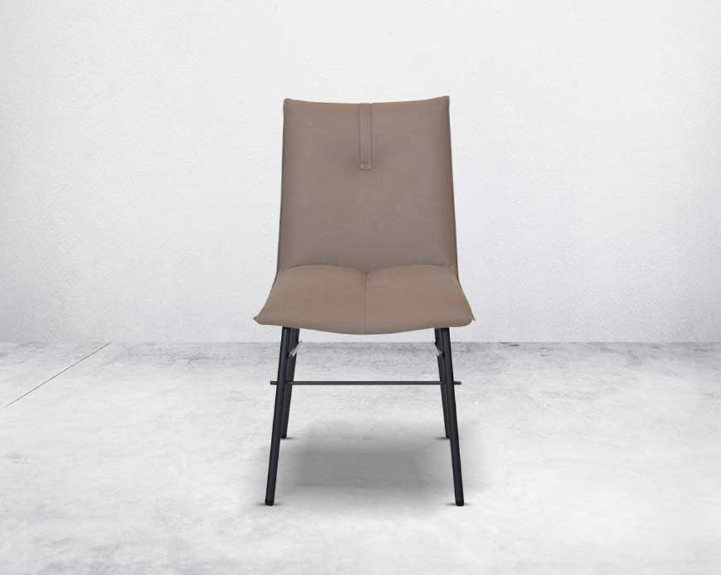 This dining chair is crafted in faux leather with matt black metal legs. It is sleek and modern in design front view