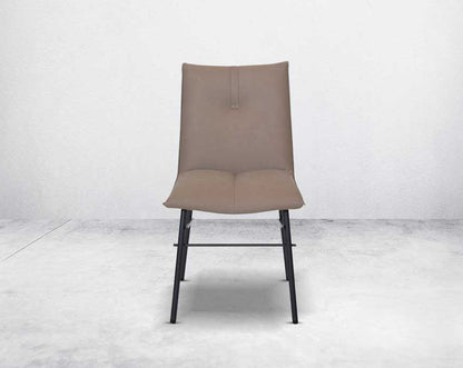 This dining chair is crafted in faux leather with matt black metal legs. It is sleek and modern in design front view