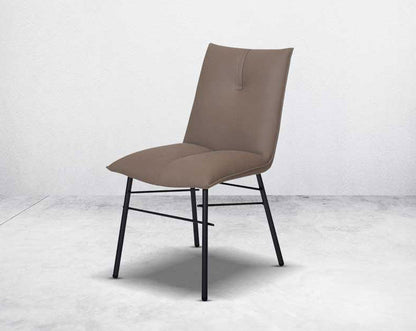 This dining chair is crafted in faux leather with matt black metal legs. It is sleek and modern in design.