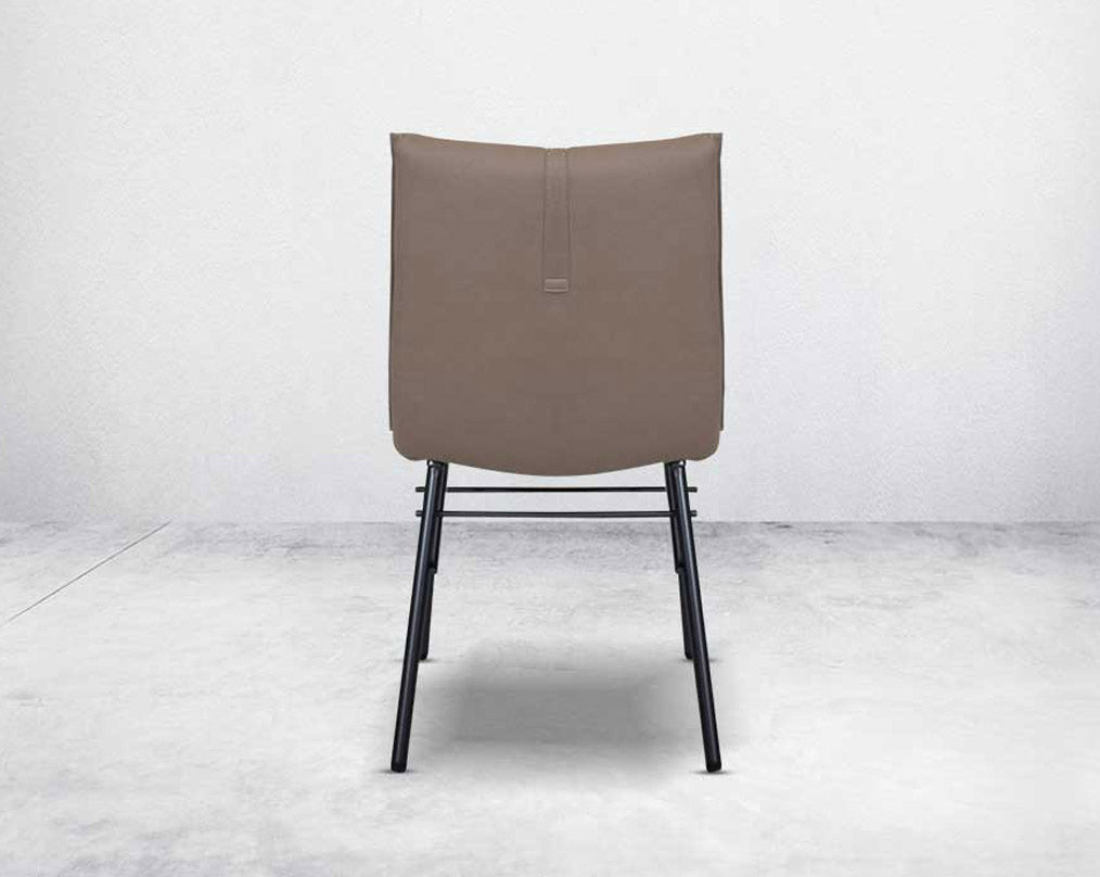 This dining chair is crafted in faux leather with matt black metal legs. It is sleek and modern in design back view