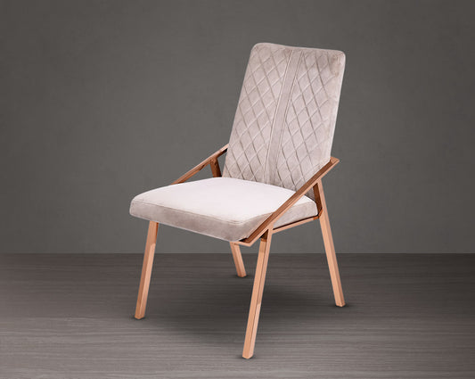 Dining chair upholstered in fabric with rose gold plated stainless steel legs.