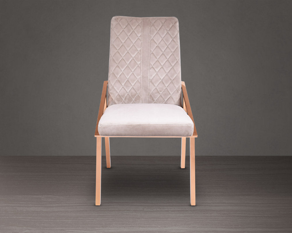 Dining chair upholstered in fabric with rose gold plated stainless steel legs.