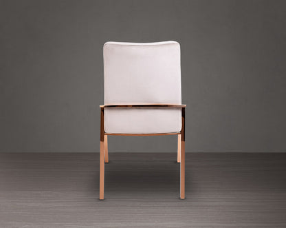 Dining chair back with  upholstered in fabric with rose gold plated stainless steel legs.