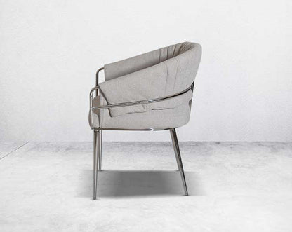 This predominantly eclectic and contemporary dining chair is upholstered in boucle fabric with glossy stainless steel frame & legs 