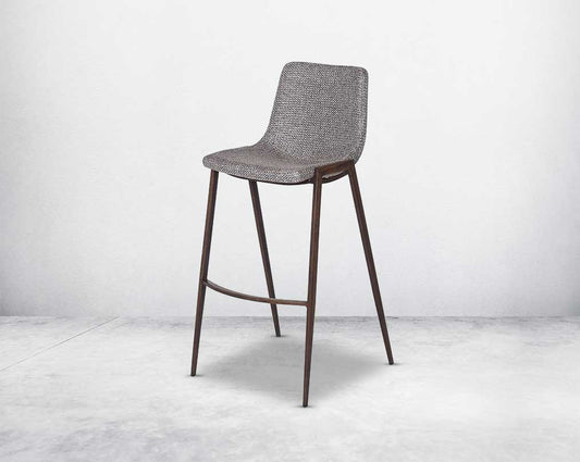 this wooden bar stool is a striking mix of industrial and modern. The supple seat, upholstered in fabric sits atop a stainless steel base in wood finish.