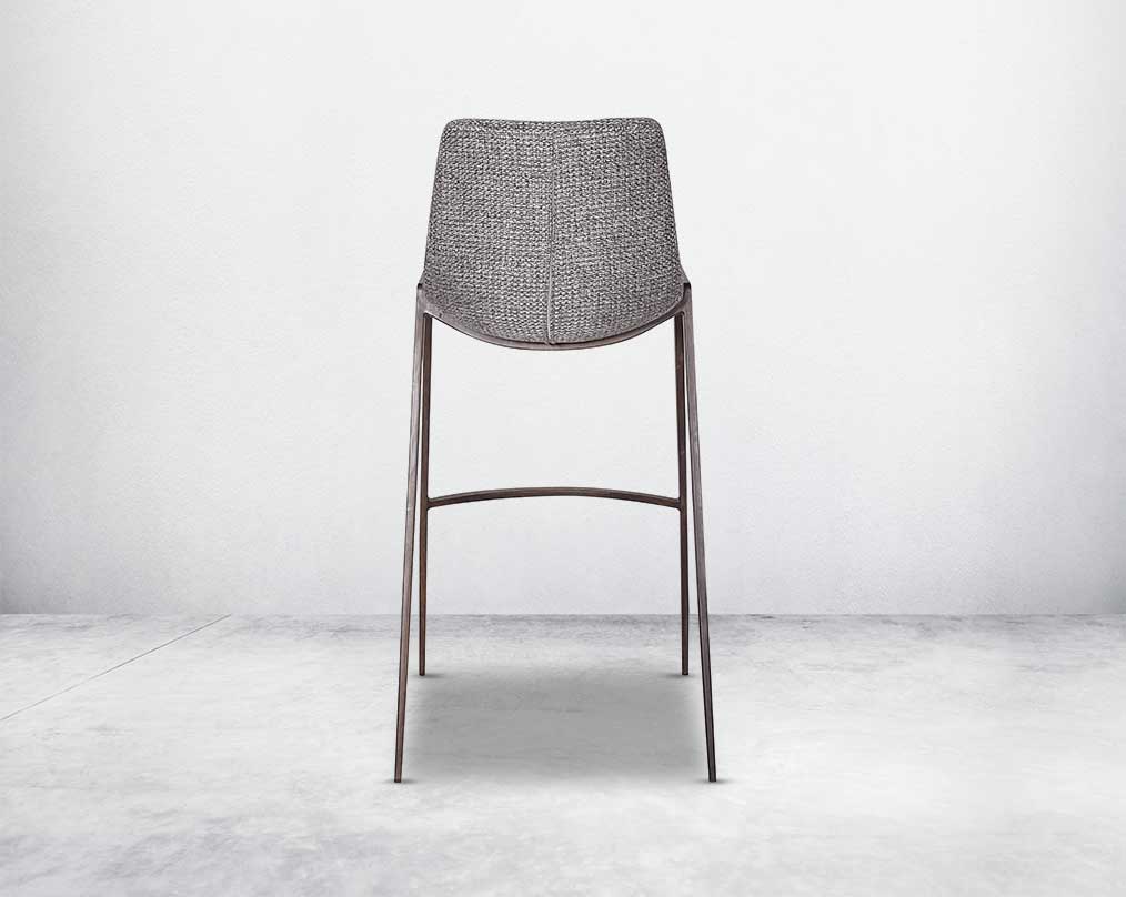 this wooden bar stool back with is a striking mix of industrial and modern. The supple seat, upholstered in fabric sits atop a stainless steel base in wood finish.