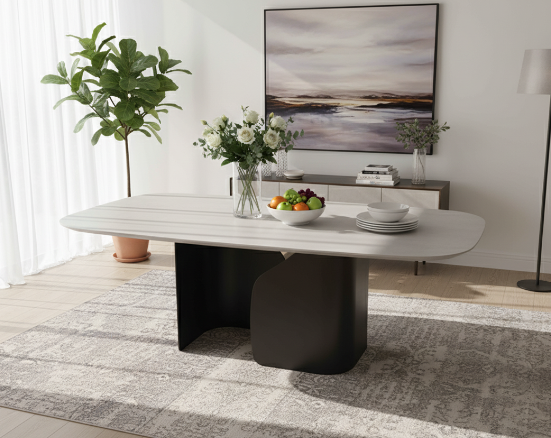 Modern dining room with a white table, decorative items, and a large painting on the wall.