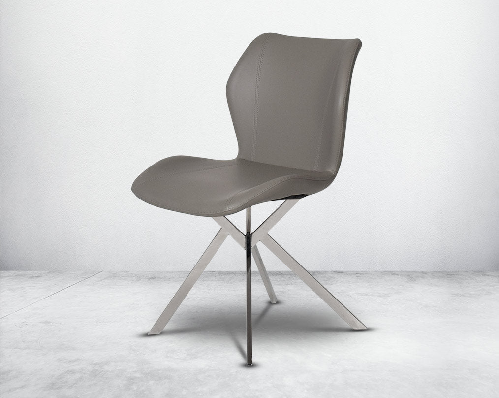 Dining chair upholstered in faux leather with stainless steel legs side view