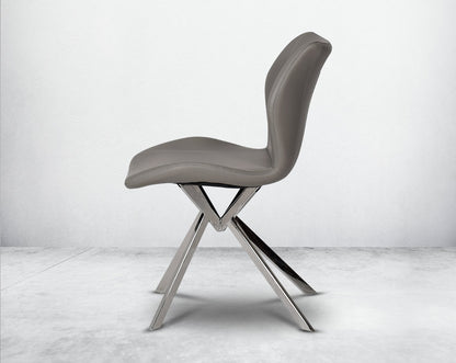 Dining chair upholstered in faux leather with stainless steel legs.