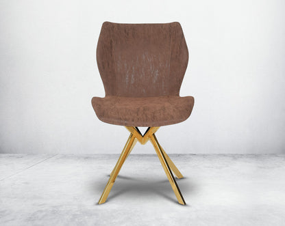 Dining chair upholstered in faux leather with high polished stainless steel legs plated in gold front view