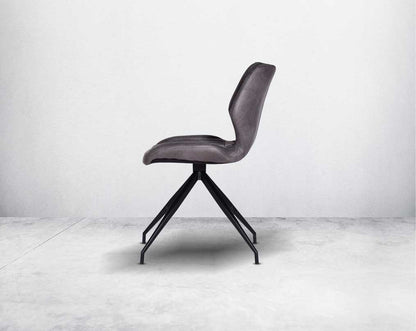 This soft, cushioned dining chair features an extraordinary contemporary design with tufted back and cushioned seat with metal legs