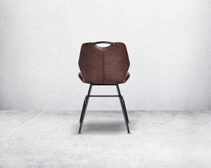 This soft, cushioned dining chair features an extraordinary contemporary design with tufted back and cushioned seat with metal legs back view