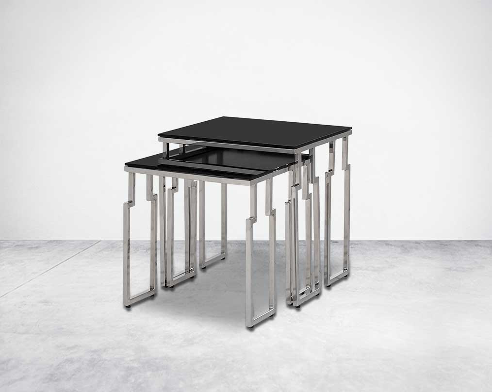 Nested tables in a set of 2 with black tempered glass top and high polished stainless steel base in rich contemporary design.