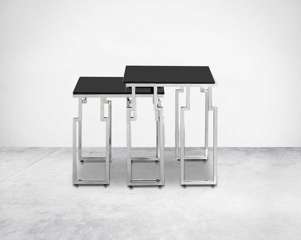 Nested tables in a set of 2 with black tempered glass top and high polished stainless steel base in rich contemporary design front view