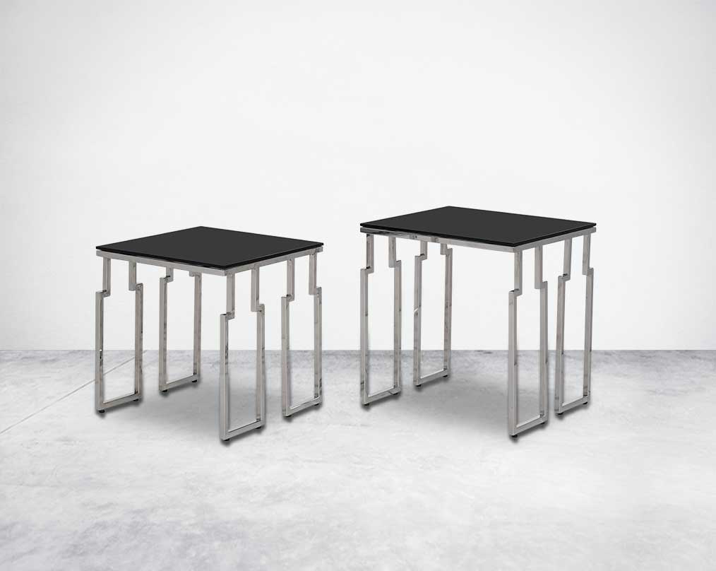 Nested tables in a set of 2 with black tempered glass top and high polished stainless steel base in rich contemporary design.