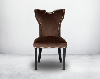 Dining chair  front upholstered in fabric with legs in wood. Stainless steel decorative ring at the back with stainless steel rivets.