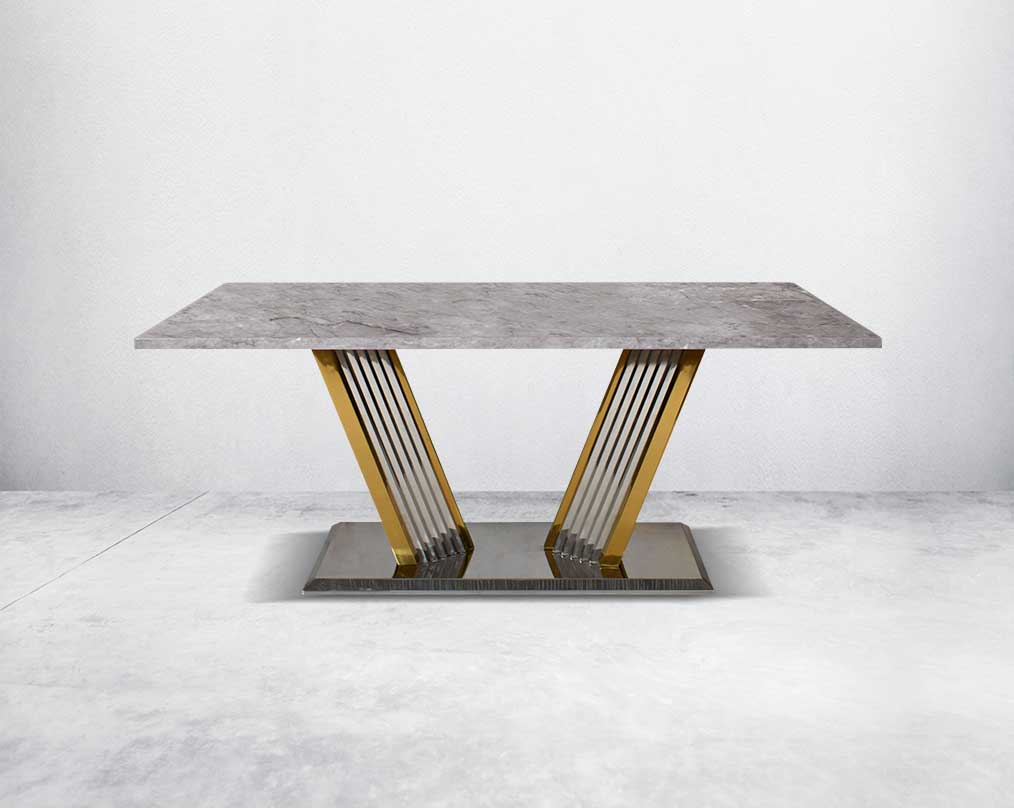 This glorious grey marble top dining table features a tree bark design motif and is crafted with a glossy gold-plated fluted stainless steel base. It makes for an opulent style statement to any home.