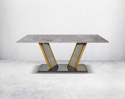 This glorious grey marble top dining table features a tree bark design motif and is crafted with a glossy gold-plated fluted stainless steel base. It makes for an opulent style statement to any home.