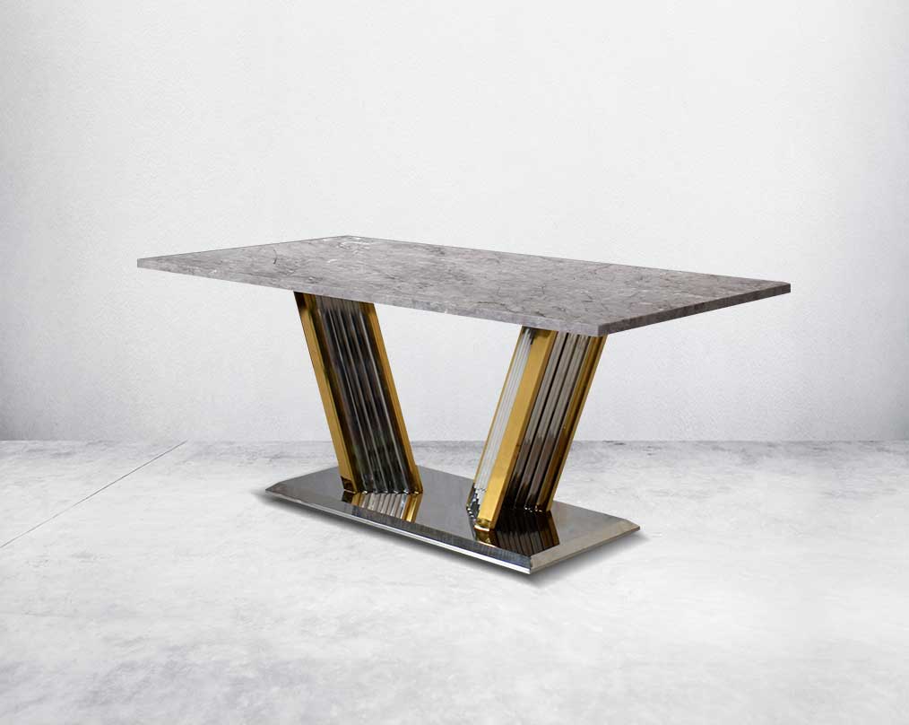 This glorious grey marble top dining table features a tree bark design motif and is crafted with a glossy gold-plated fluted stainless steel base. It makes for an opulent style statement to any home.