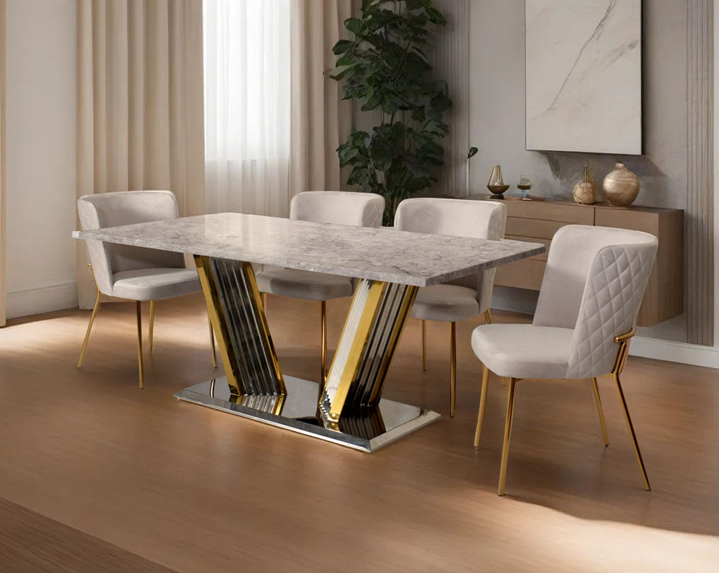 This glorious grey marble top dining table features a tree bark design motif and is crafted with a glossy gold-plated fluted stainless steel base. It makes for an opulent style statement to any home.

Minimalistically designed chair with criss-cross sti