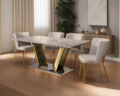 This glorious grey marble top dining table features a tree bark design motif and is crafted with a glossy gold-plated fluted stainless steel base. It makes for an opulent style statement to any home.

Minimalistically designed chair with criss-cross sti
