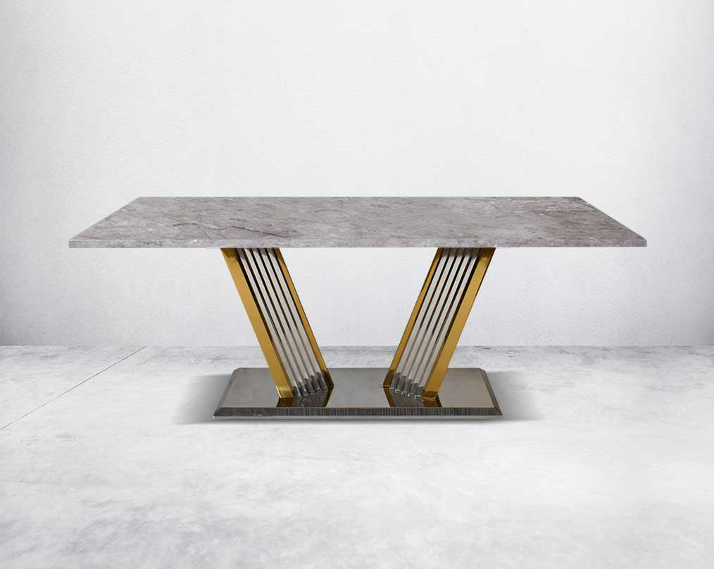 This glorious grey marble top dining table features a tree bark design motif and is crafted with a glossy gold-plated fluted stainless steel base.
