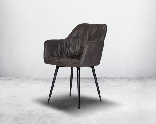 This soft, cushioned dining chair features an extraordinary contemporary design with tufted back and cushioned seat with metal legs.