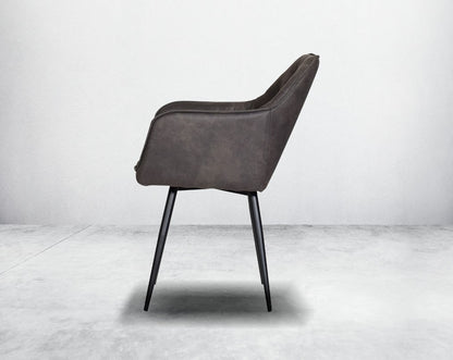 This soft, cushioned dining chair features an extraordinary contemporary design with tufted back and cushioned seat with metal legs side view