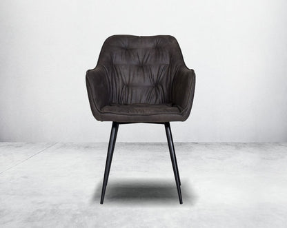 This soft, cushioned dining chair features an extraordinary contemporary design with tufted back and cushioned seat with metal legs front view