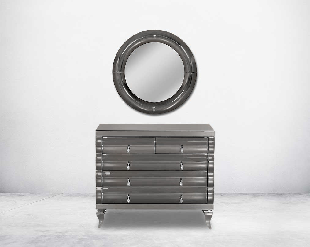 Chest of drawers in a grey curved mirror.