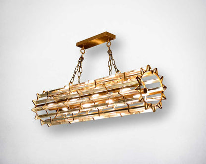 Cylindrical crystal glass pendant lamp with metal brass plated.