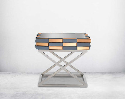 End table with clear glass top with grey & tawny mirror & high polished stainless steel legs in a cross design front view