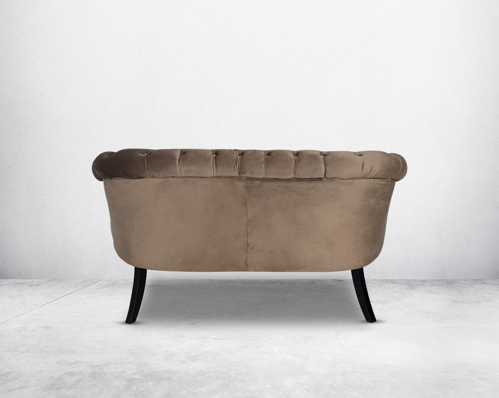 Two Seater Wing lounge chair back with  upholstered in velvet fabric with tufted back and seat with steel rivets on the arms.