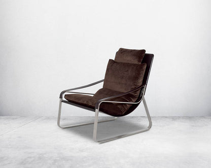 Leisure chair upholstered in fabric with high polished stainless steel frame.