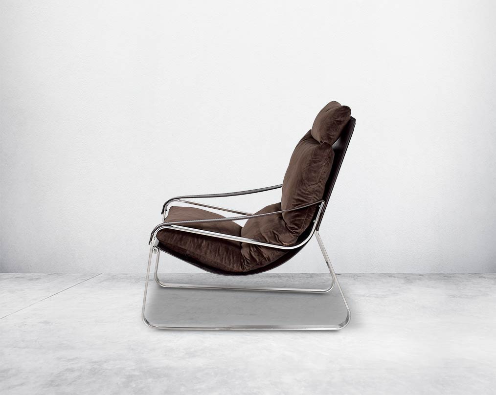 Leisure chair upholstered in fabric with high polished stainless steel frame.